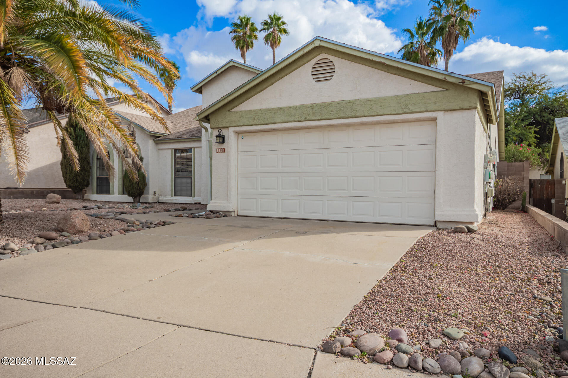 5331 West Eaglestone Loop Tucson, AZ 85742 - Photo 4 of 35 a front view of a house with a yard and garage