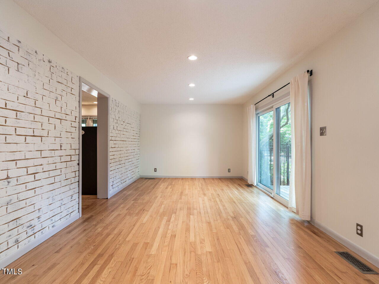 2204 Myron Drive Raleigh, NC 27607 - Photo 12 of 57 The painted brick wall adds texture and warmth.
