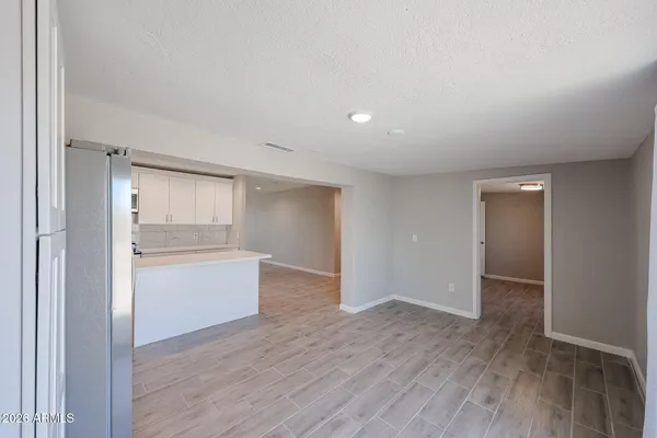 a view of an empty room and wooden floor