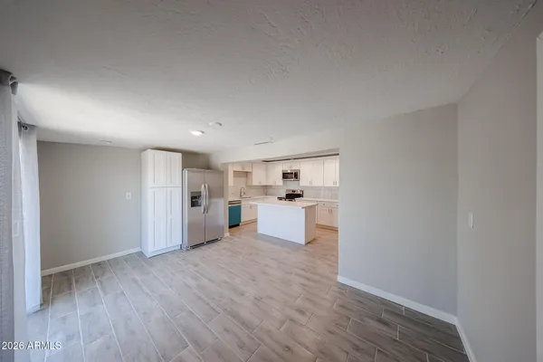 a view of a kitchen with wooden floor