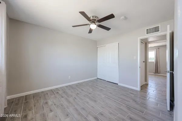 a view of an empty room with wooden floor