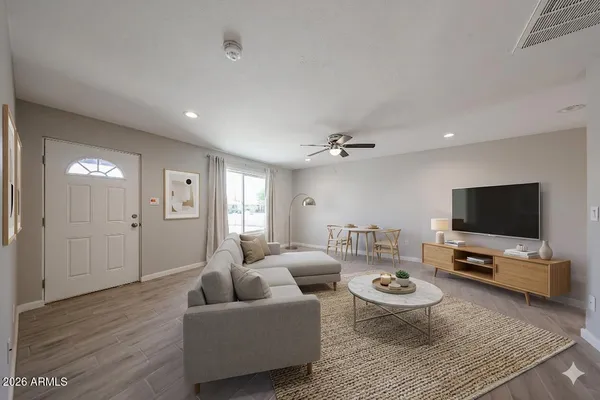 a living room with furniture and a flat screen tv