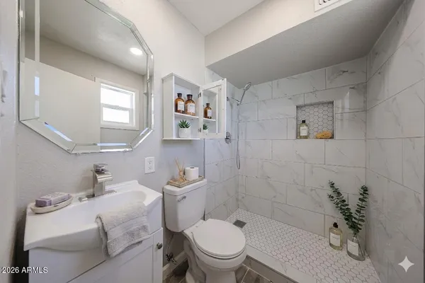 a bathroom with a sink toilet and shower