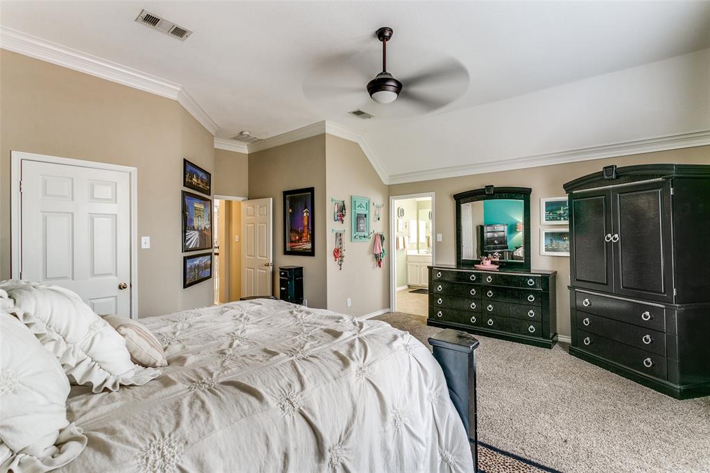 227 Moss Hill Road Irving, TX 75063 - Photo 20 of 27 a bedroom with a bed and a dresser