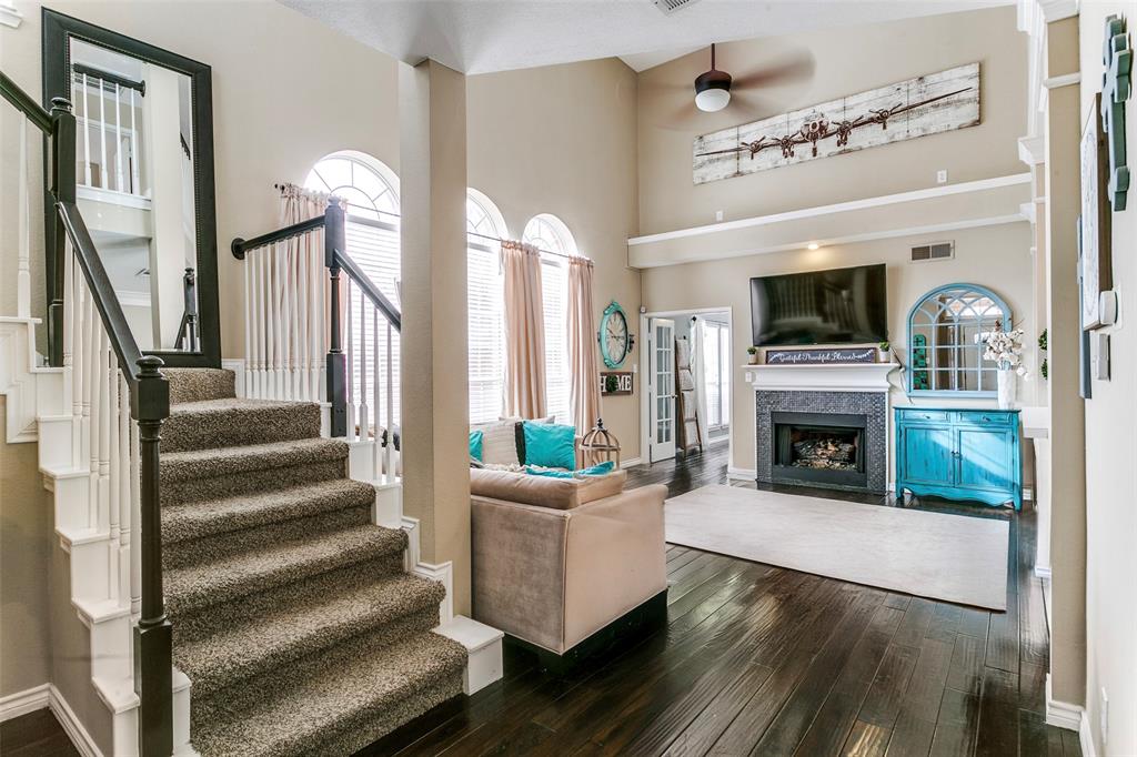 227 Moss Hill Road Irving, TX 75063 - Photo 2 of 27 a living room with furniture a fireplace and a flat screen tv