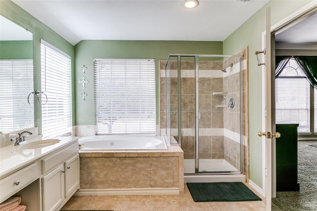 227 Moss Hill Road Irving, TX 75063 - Photo 21 of 27 a bathroom with a tub a sink and a shower