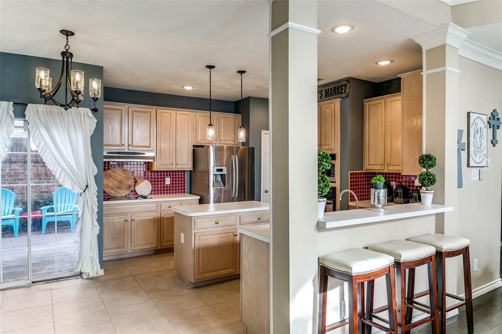 227 Moss Hill Road Irving, TX 75063 - Photo 9 of 27 a kitchen that has a lot of cabinets in it and wooden floors