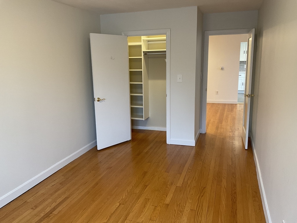 26 Summer Street, Unit 8 Marblehead, MA 01945 - Photo 14 of 23 an empty room with wooden floor and closet