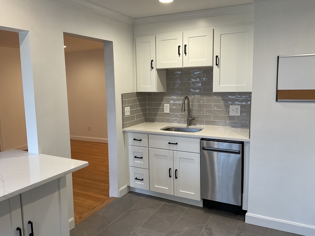 26 Summer Street, Unit 8 Marblehead, MA 01945 - Photo 3 of 23 a kitchen with white cabinets and sink
