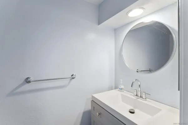 a bathroom with a sink and mirror