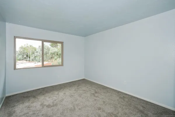 an empty room with sliding glass door