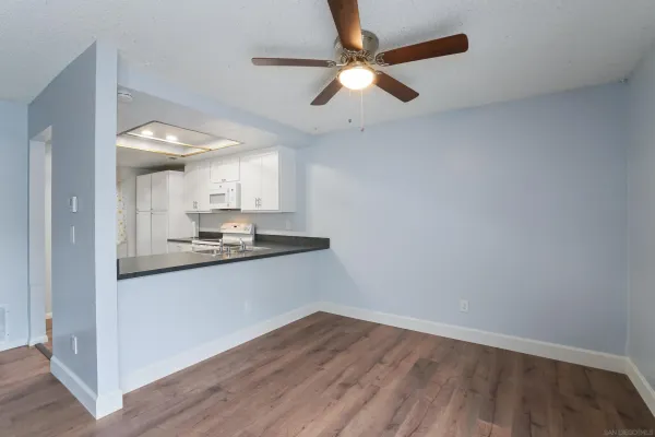 a view of a kitchen with a sink and wooden floor