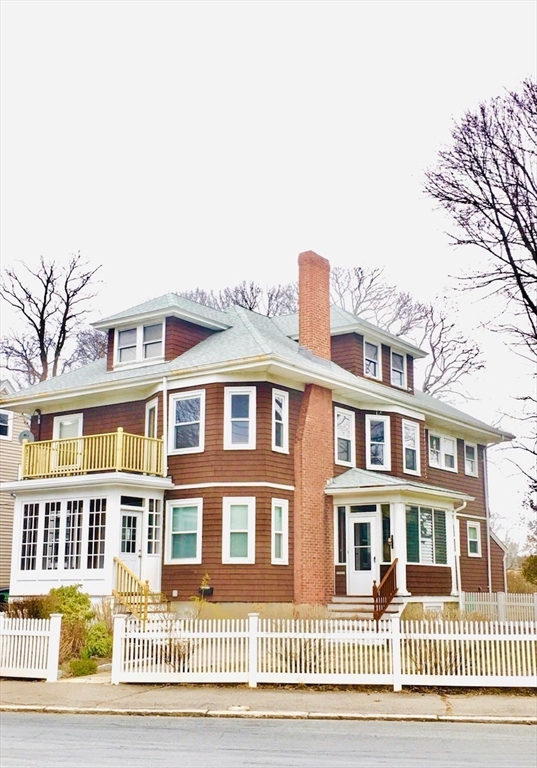 a front view of a residential apartment building with a yard