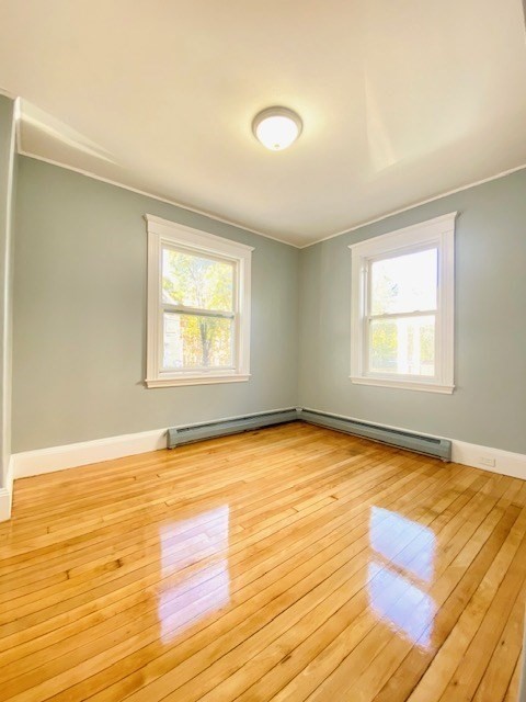 117 Beach Street Quincy, MA 02170 - Photo 12 of 20 a view of an empty room with wooden floor and a window