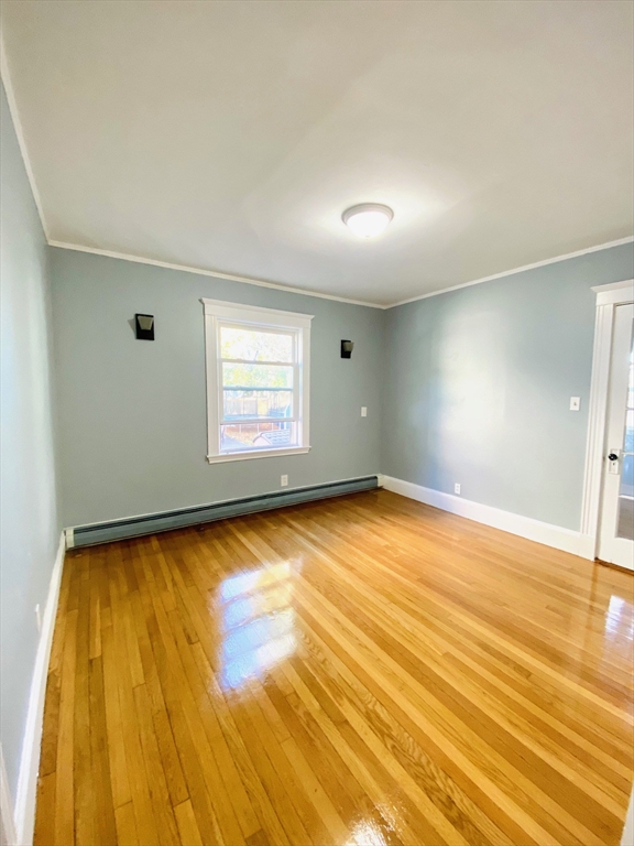 117 Beach Street Quincy, MA 02170 - Photo 14 of 20 a view of empty room with window and wooden floor