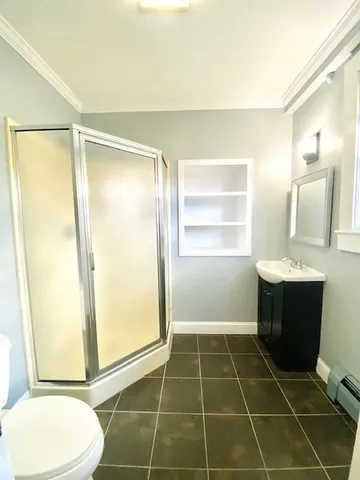 a bathroom with a sink toilet and shower
