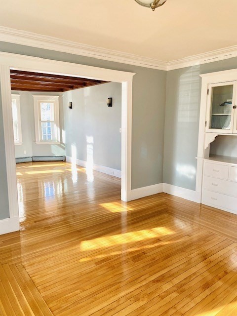 117 Beach Street Quincy, MA 02170 - Photo 8 of 20 a view of empty room with wooden floor and kitchen view