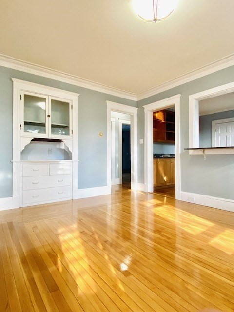 117 Beach Street Quincy, MA 02170 - Photo 9 of 20 a view of an empty room with a kitchen and a sink