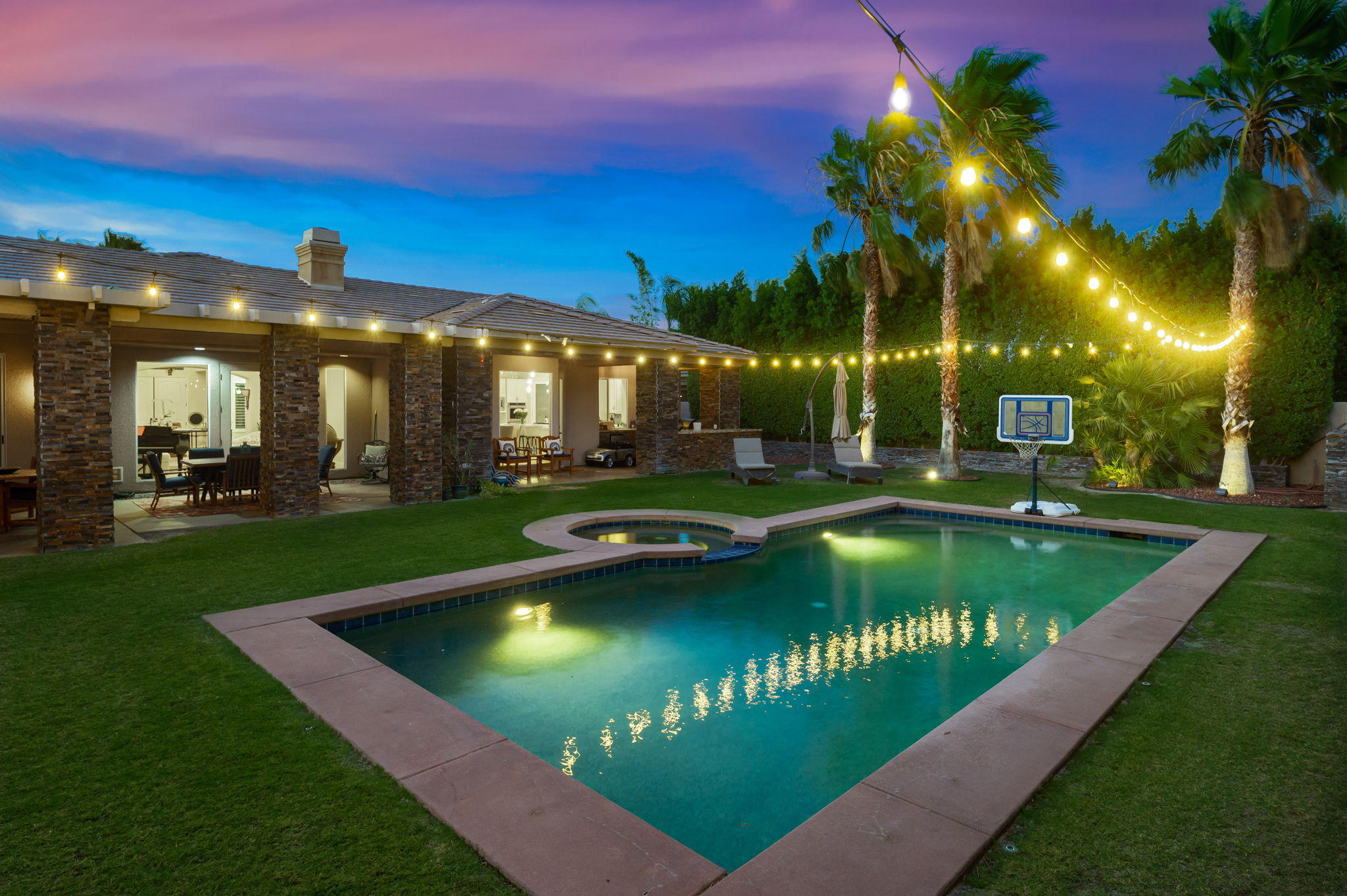 43 Provence Way Rancho Mirage, CA 92270 - Photo 1 of 31 a view of a swimming pool with lawn chairs under an umbrella