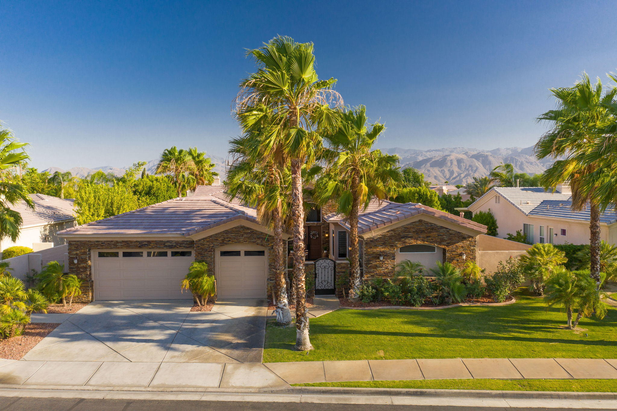 43 Provence Way Rancho Mirage, CA 92270 - Photo 30 of 31 a front view of a house with a garden and trees