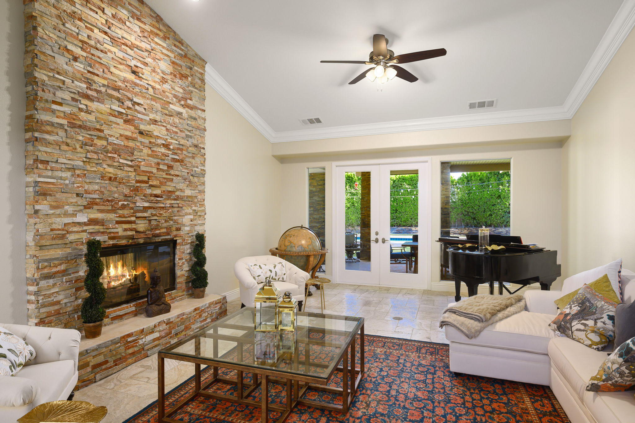 43 Provence Way Rancho Mirage, CA 92270 - Photo 5 of 31 a living room with furniture a fireplace and a floor to ceiling window