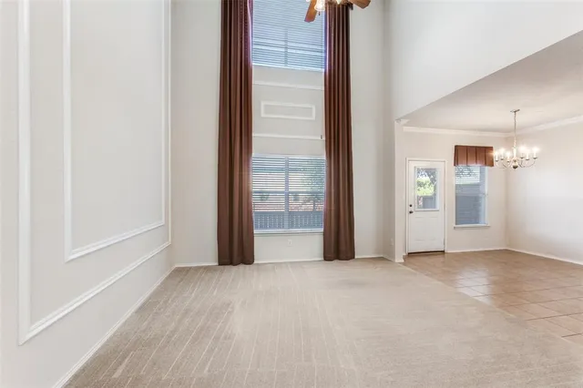 a view of a room with an empty space and wooden floor