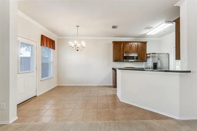 a view of a kitchen cabinets a sink and a microwave