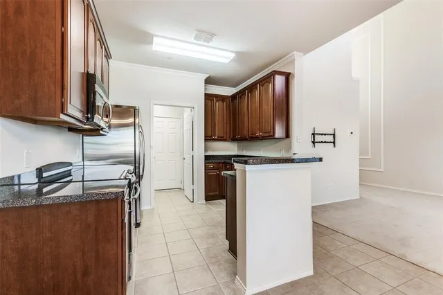 a kitchen with a refrigerator sink and cabinets