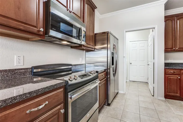 a kitchen with cabinets and steel stainless steel appliances