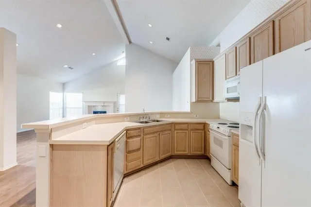 a kitchen with a sink stove and refrigerator