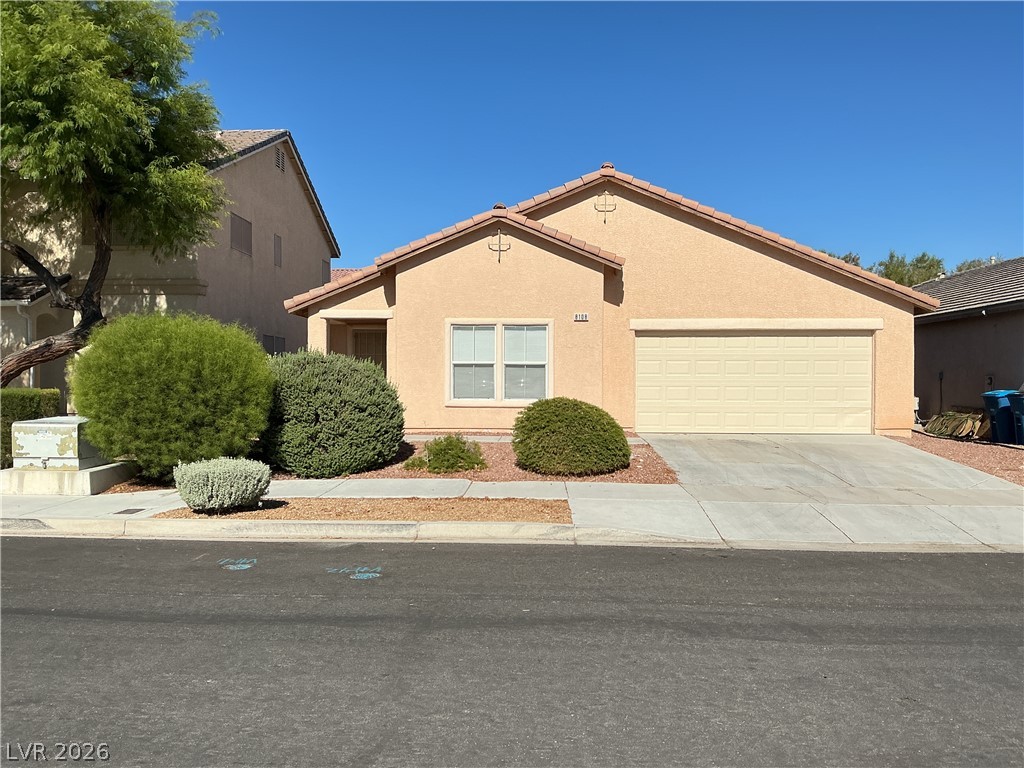 8108 Roundup Ridge Street Las Vegas, NV 89131 - Photo 2 of 21 A single-story home with desert-friendly landscaping, an attached garage, and a welcoming entry.