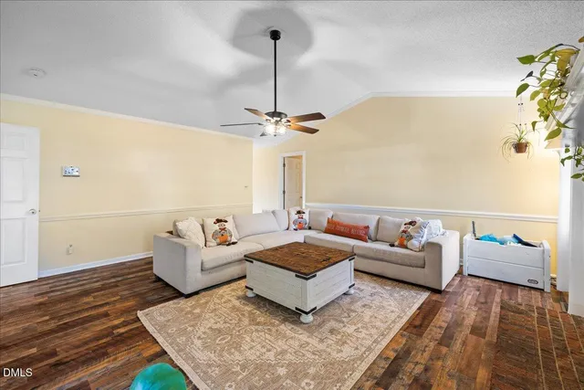 a living room with furniture a fireplace and a chandelier