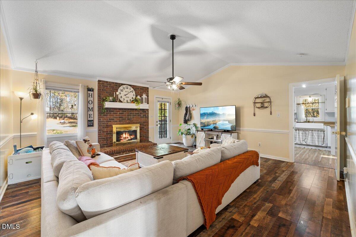 850 Lewis Winstead Loop Roxboro, NC 27574 - Photo 12 of 49 a living room with furniture a fireplace and a chandelier