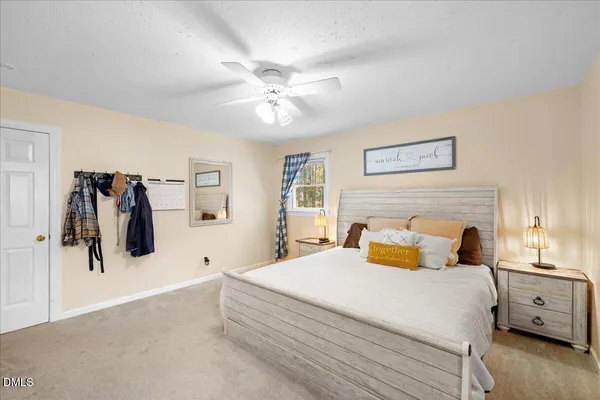 a spacious bedroom with a bed and a couch