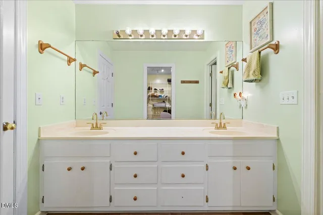 a bathroom with a double vanity sink and a mirror