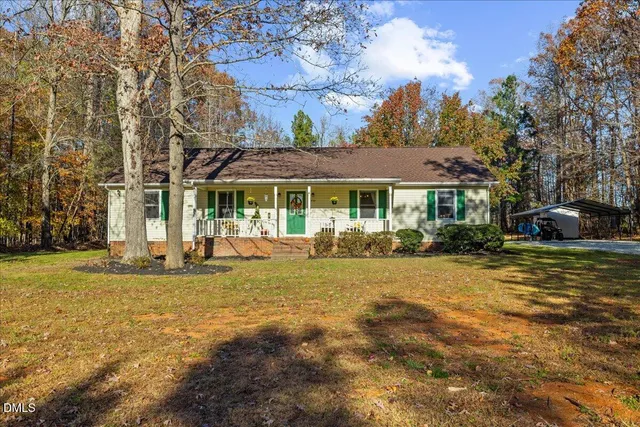 a view of a house with pool and sitting area
