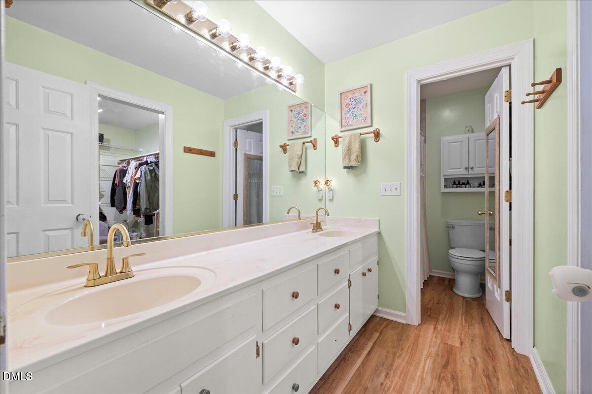 850 Lewis Winstead Loop Roxboro, NC 27574 - Photo 22 of 49 a bathroom with a double vanity sink and a mirror