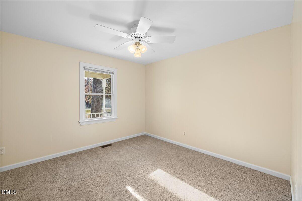 850 Lewis Winstead Loop Roxboro, NC 27574 - Photo 26 of 49 an empty room with windows and fan