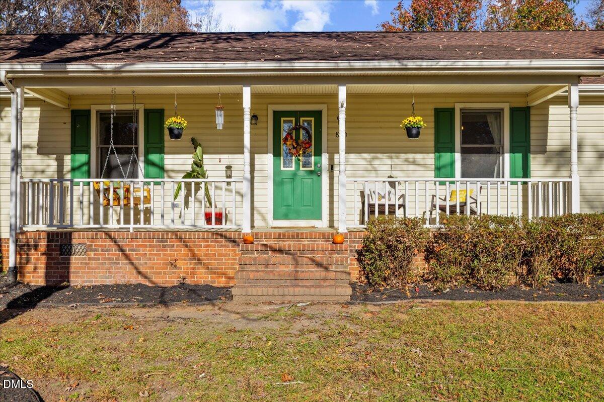 850 Lewis Winstead Loop Roxboro, NC 27574 - Photo 3 of 49 front view of a building with a garden