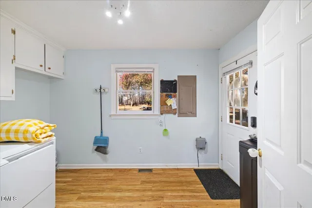 a view of a house with a yard and tree s