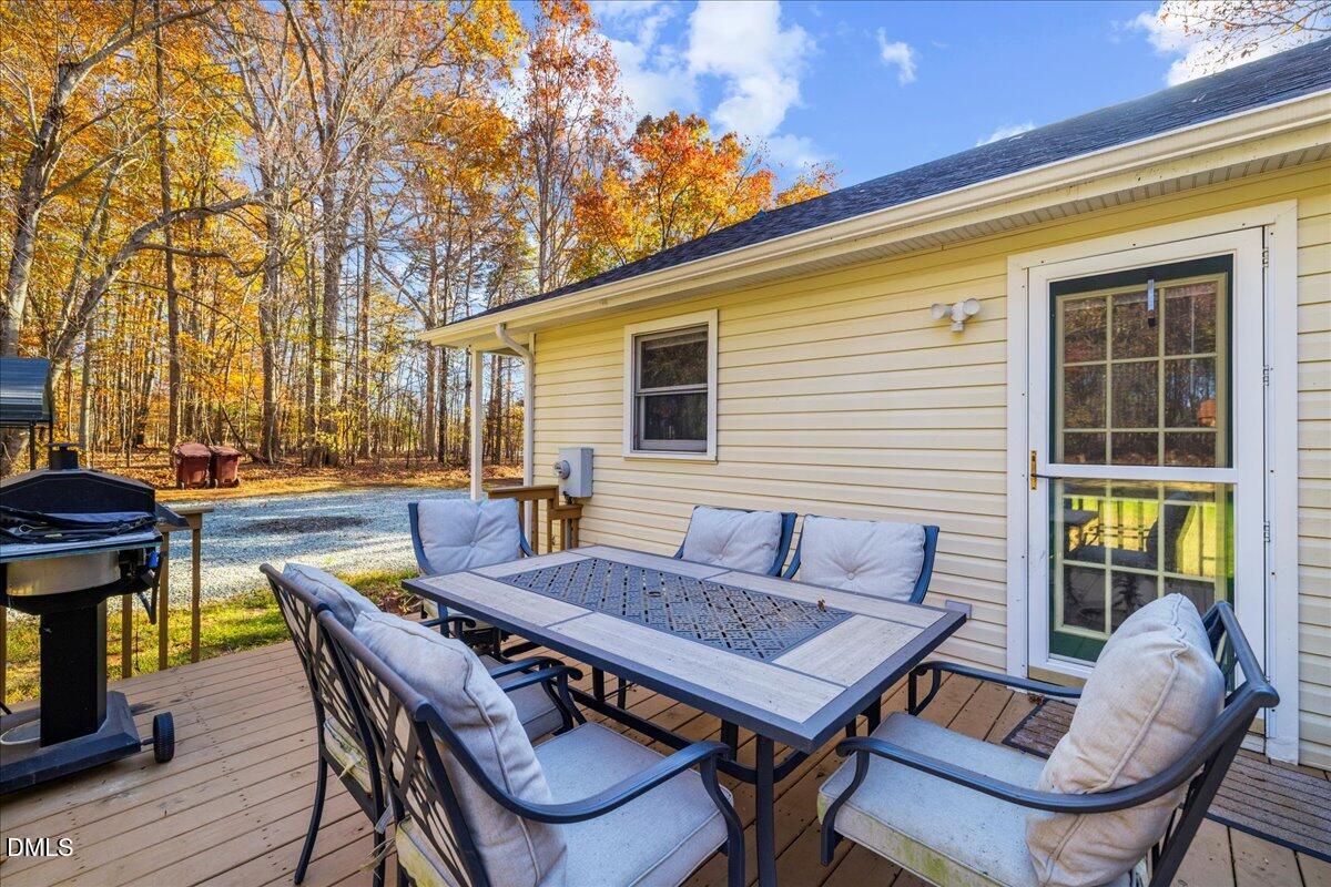 850 Lewis Winstead Loop Roxboro, NC 27574 - Photo 37 of 49 a backyard of a house with barbeque oven table and chairs