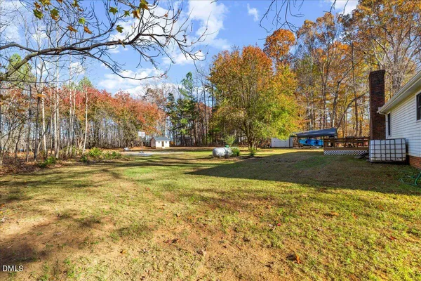 a backyard of a house with large trees