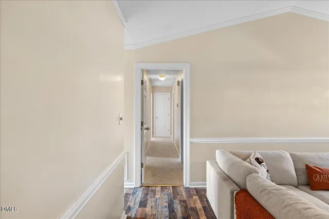 a living room with furniture a fireplace and a chandelier