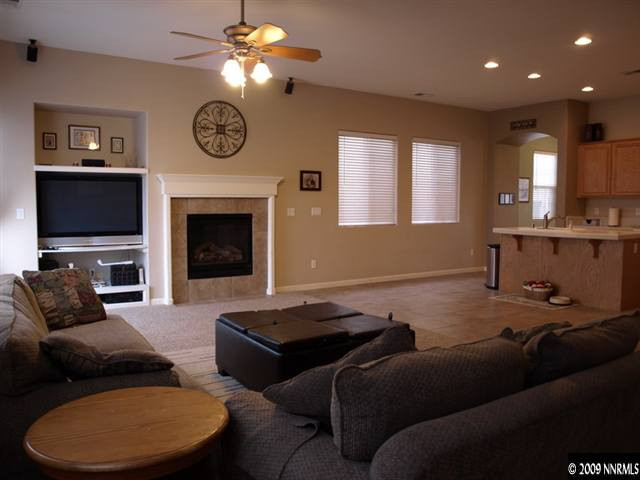 10633 Eagle Falls Way Reno, NV 89521 - Photo 5 of 9 a living room with furniture a fireplace and a flat screen tv