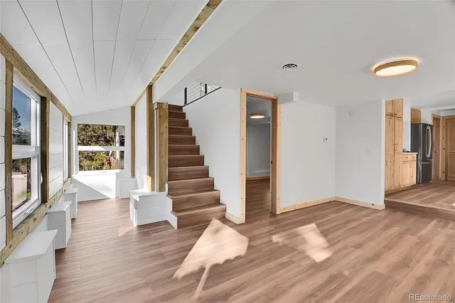 a view of entryway with wooden floor and stair