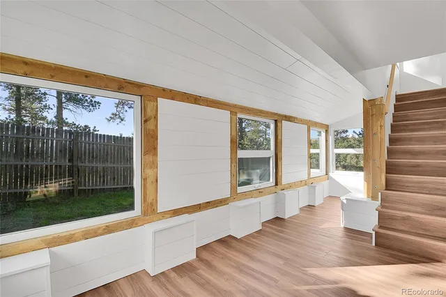 a view of an entryway with wooden floor