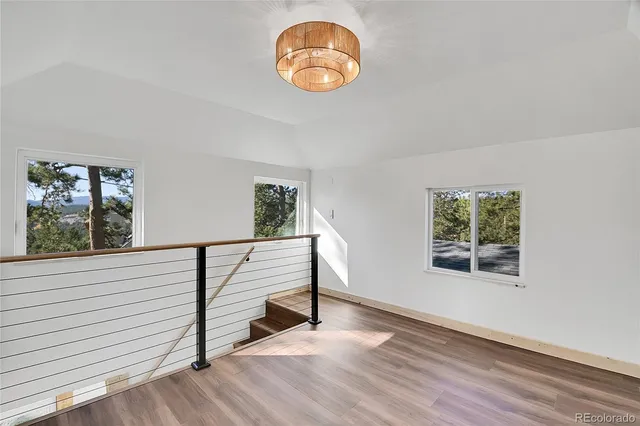 a view of a room with wooden floor and window