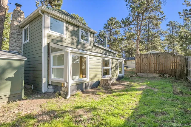 a front view of house with yard outdoor seating and barbeque oven