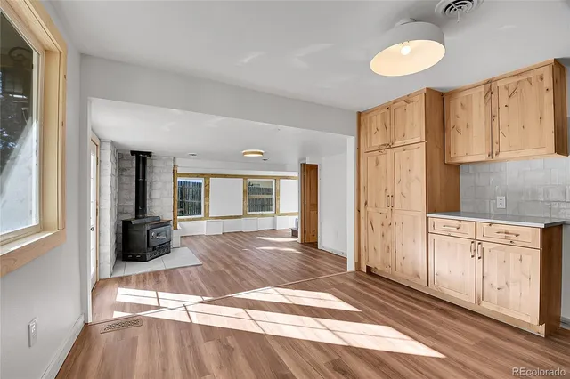 a view of a kitchen with wooden floor and staircase