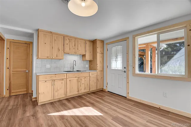 a kitchen with granite countertop wooden cabinets a sink and a window